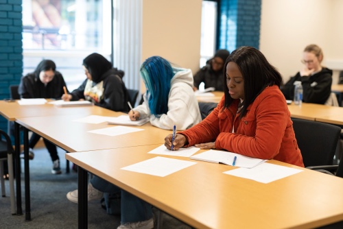 Meeting room, delegates writing